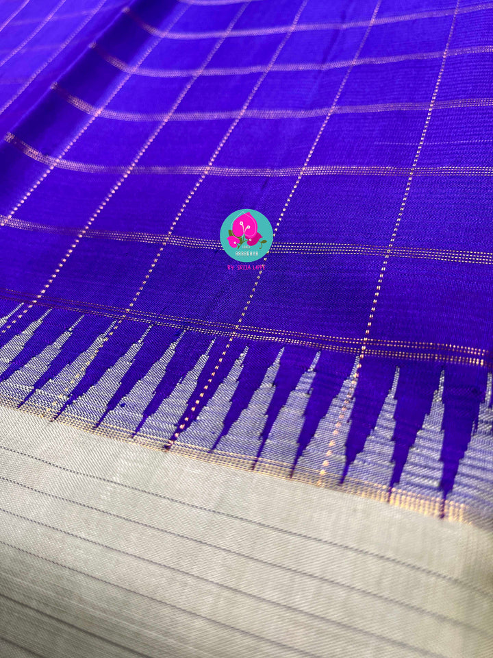 Royal blue checkered saree with a touch of pastel pista color