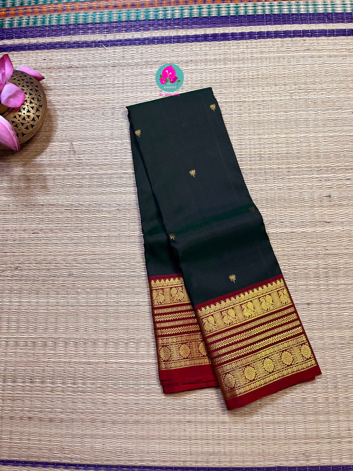 Pure Kanchipattu saree with Lotus Motifs in deep bottle green