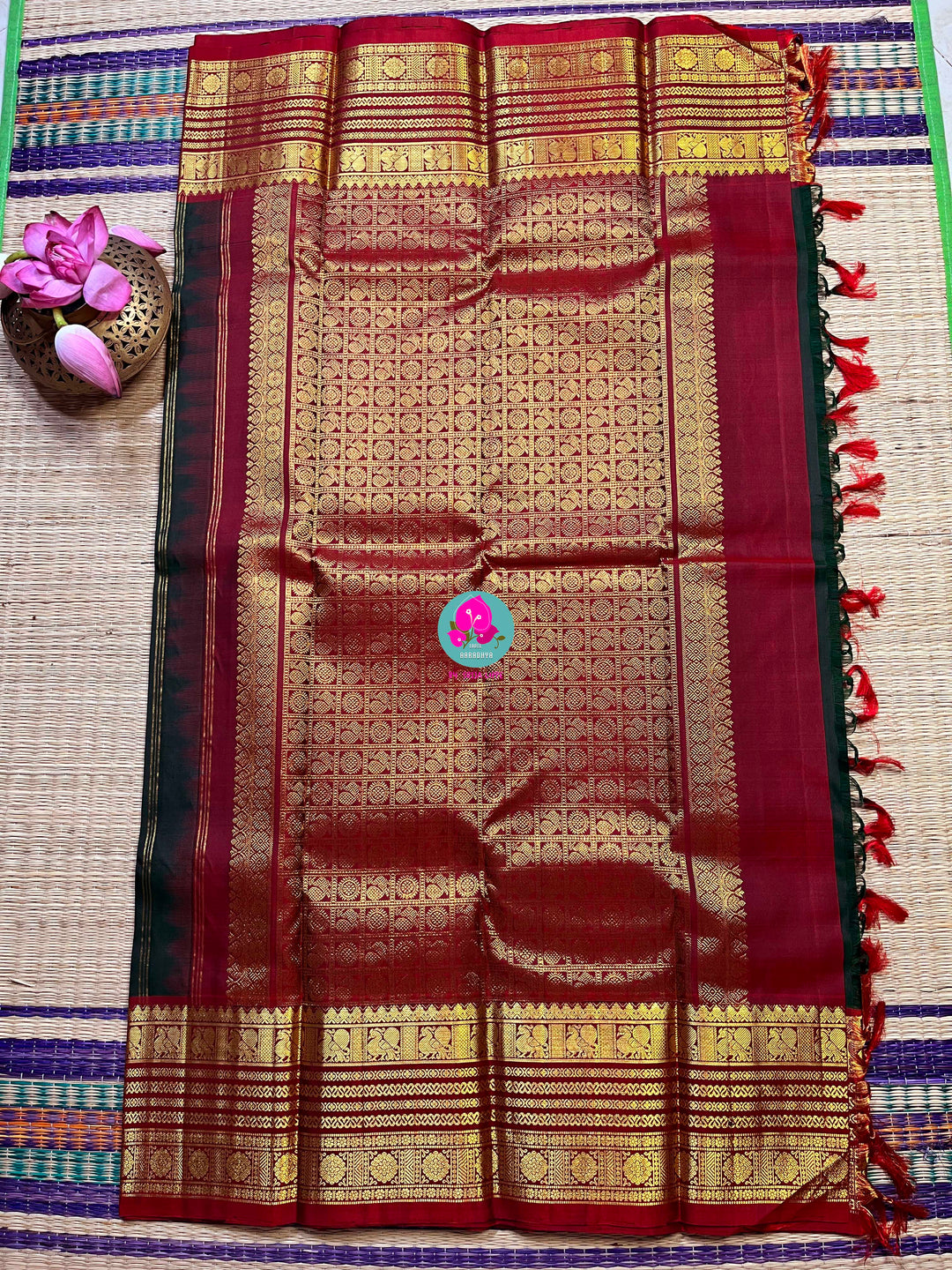 Pure Kanchipattu saree with Lotus Motifs in deep bottle green