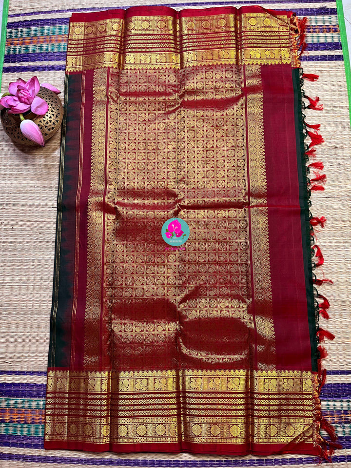 Pure Kanchipattu saree with Lotus Motifs in deep bottle green
