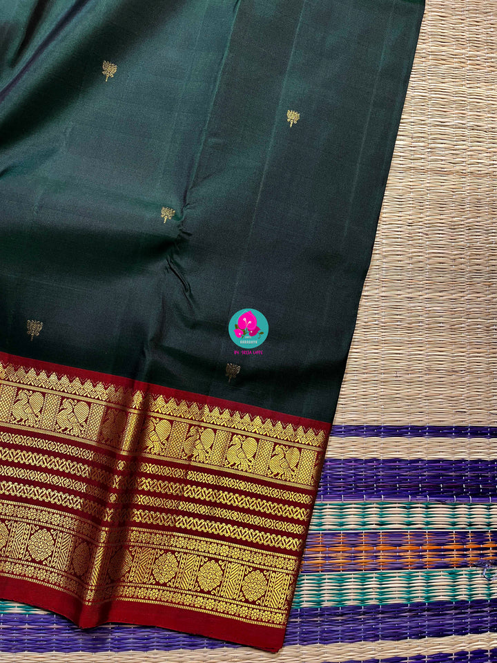 Pure Kanchipattu saree with Lotus Motifs in deep bottle green