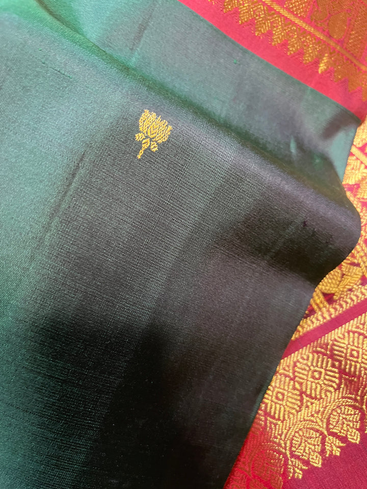 Pure Kanchipattu saree with Lotus Motifs in deep bottle green