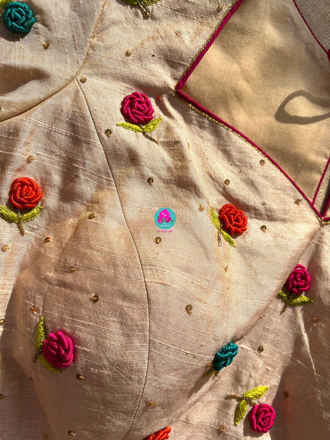 Semi Banarasi Silk Saree paired with pure tissue rawsilk blouse embroidered with rose knot