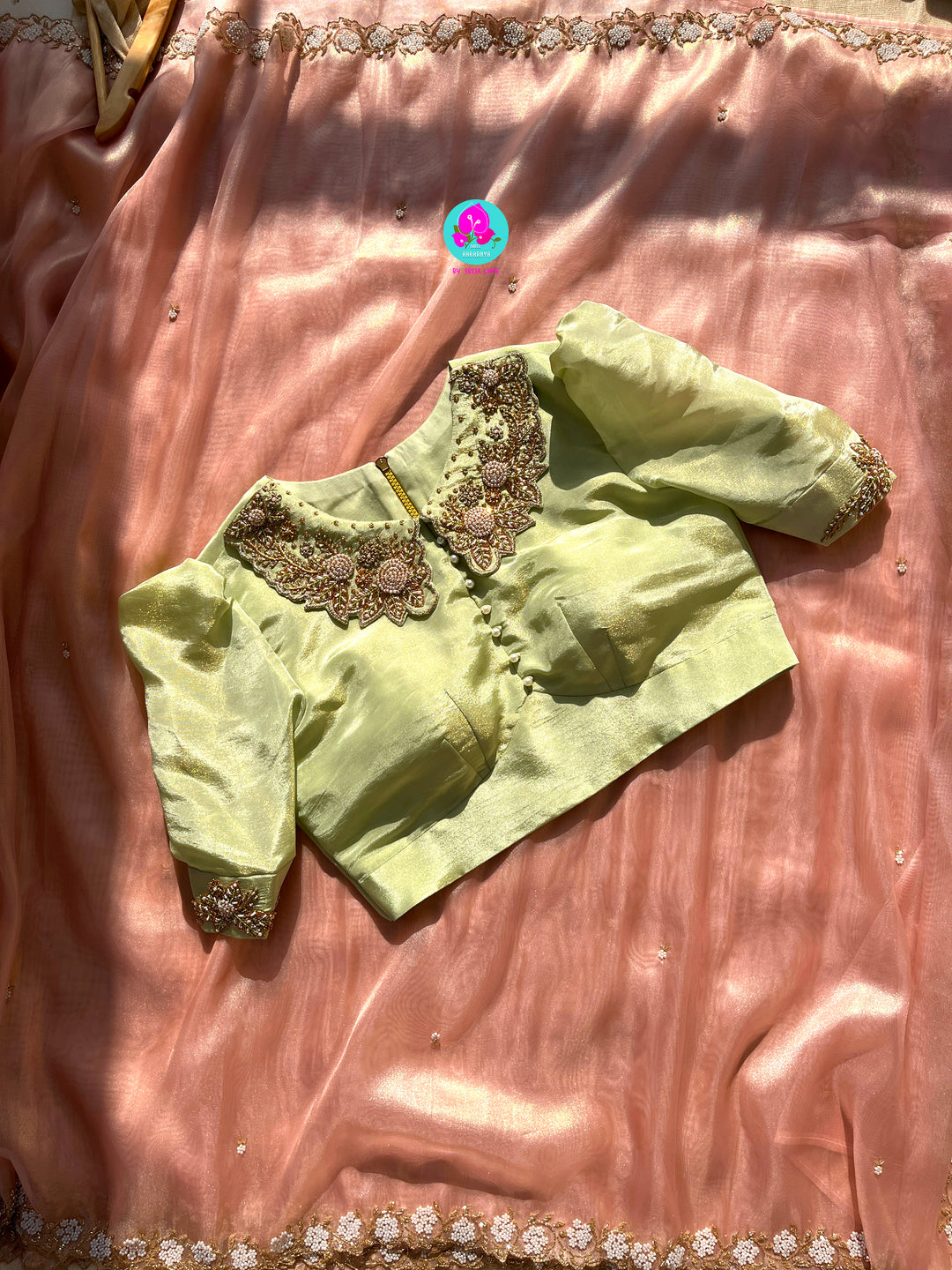 We call it a cocktail soft tissue silk saree with a flowy drape, paired with a Peter Pan collar blouse in matching tissue.