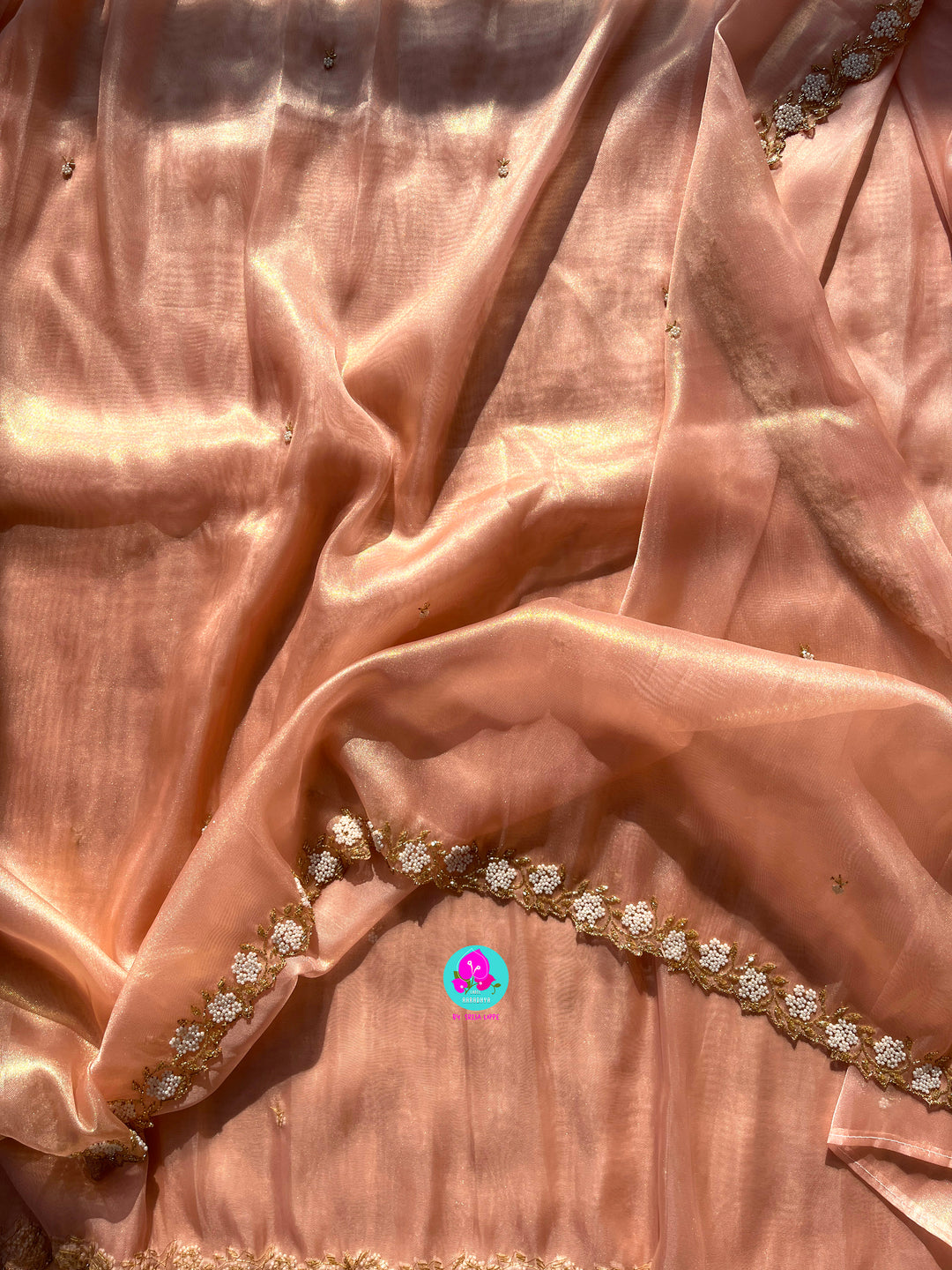 We call it a cocktail soft tissue silk saree with a flowy drape, paired with a Peter Pan collar blouse in matching tissue.