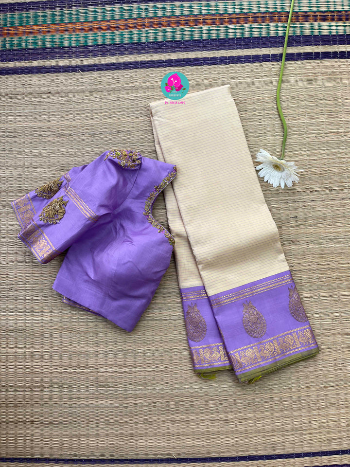 Creamish offwhite Kanchipattu saree with a contrast green and lavender combination