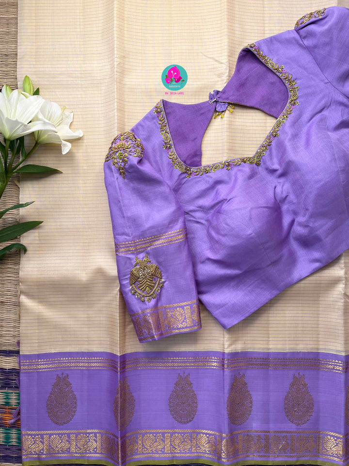 Creamish offwhite Kanchipattu saree with a contrast green and lavender combination