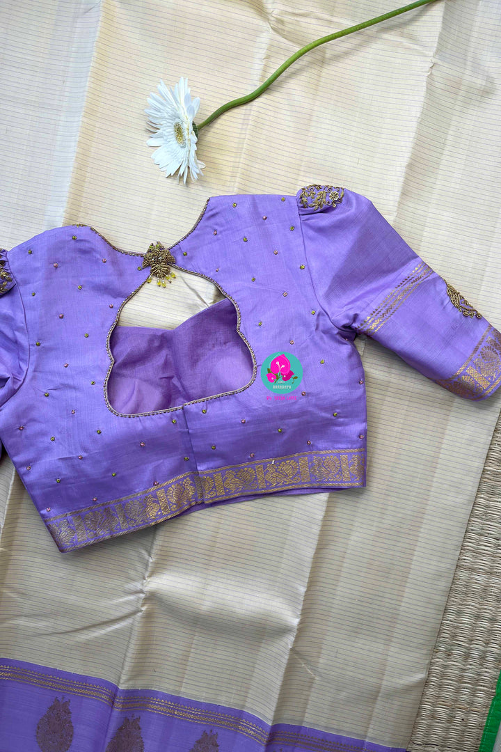Creamish offwhite Kanchipattu saree with a contrast green and lavender combination