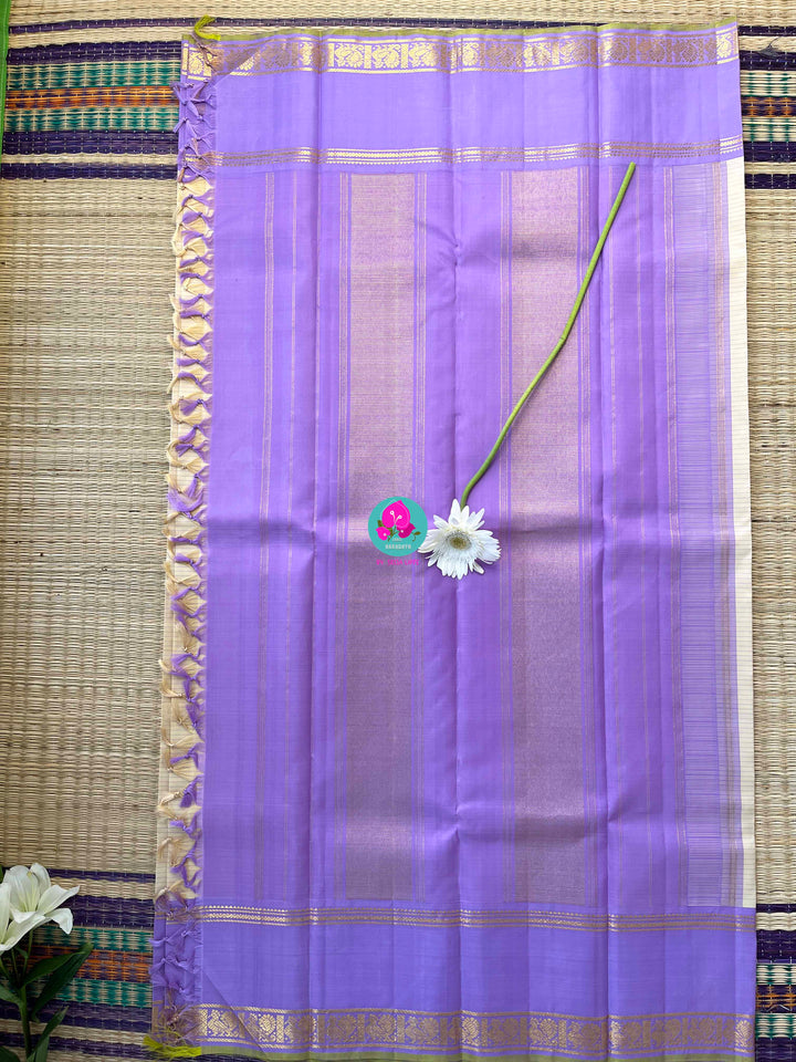 Creamish offwhite Kanchipattu saree with a contrast green and lavender combination