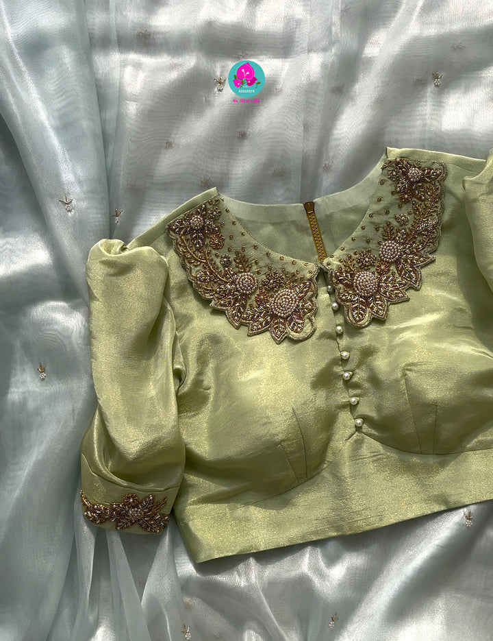 We call it a cocktail soft tissue silk saree with a flowy drape, paired with a Peter Pan collar blouse in matching tissue