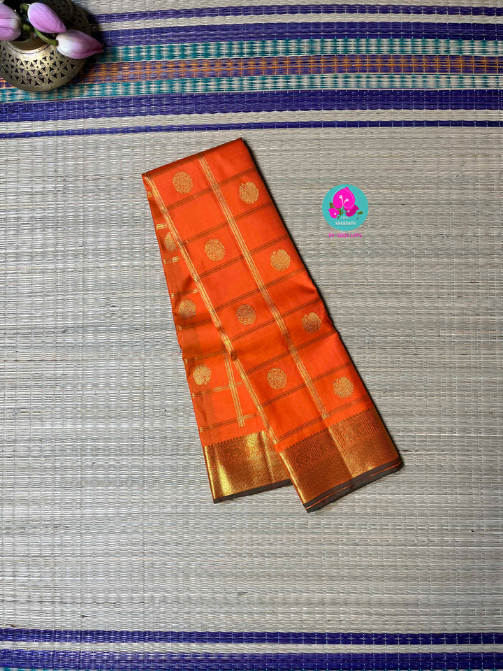 Beautiful orange color pure Kanchipattu saree with Belldari Checkered butta