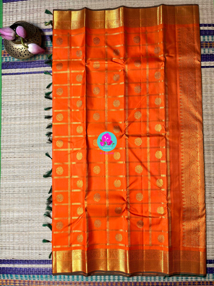 Beautiful orange color pure Kanchipattu saree with Belldari Checkered butta
