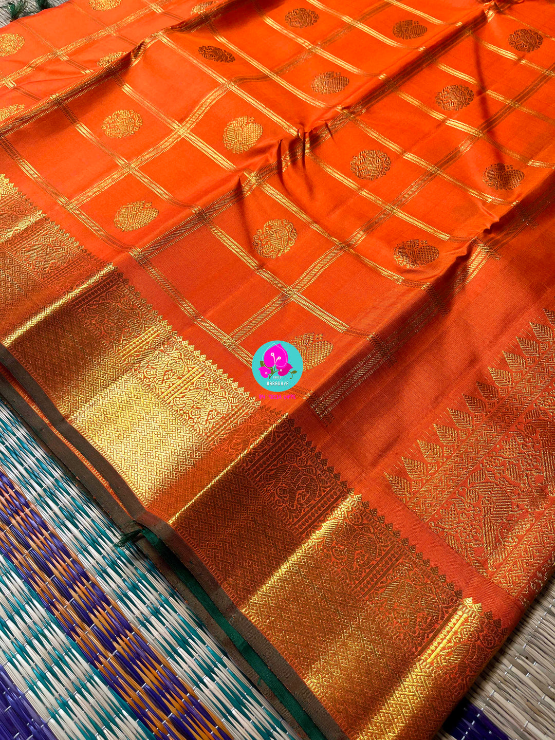 Beautiful orange color pure Kanchipattu saree with Belldari Checkered butta