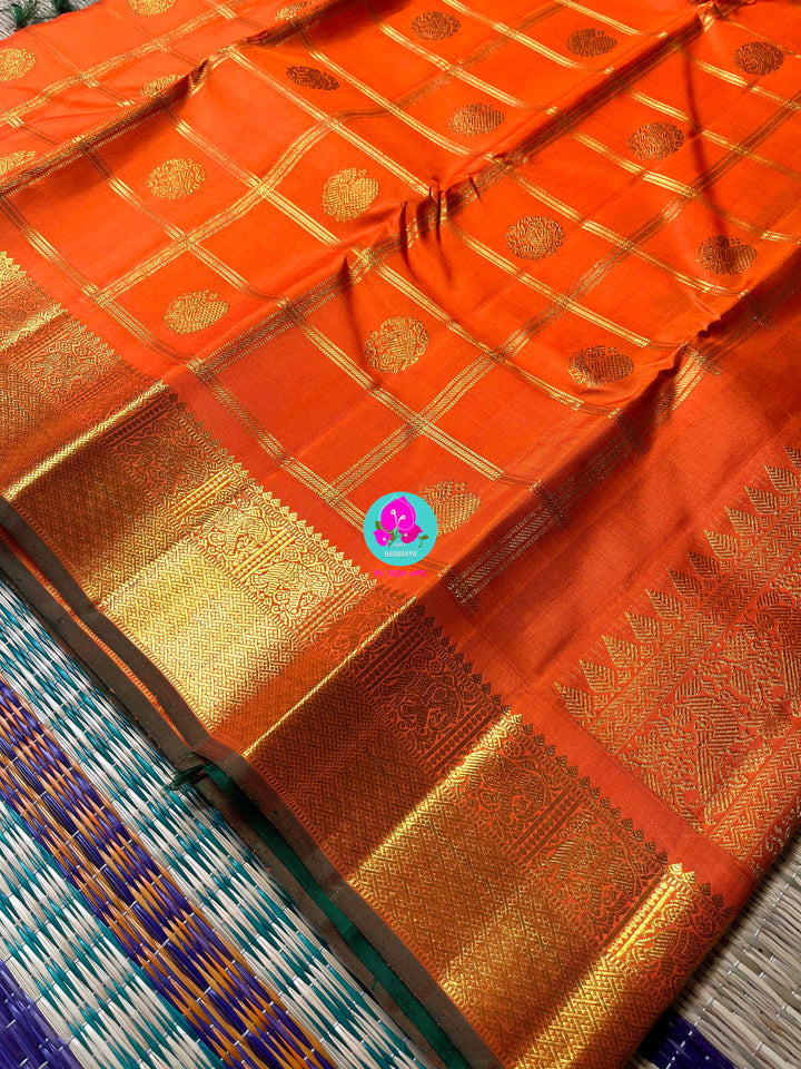 Beautiful orange color pure Kanchipattu saree with Belldari Checkered butta