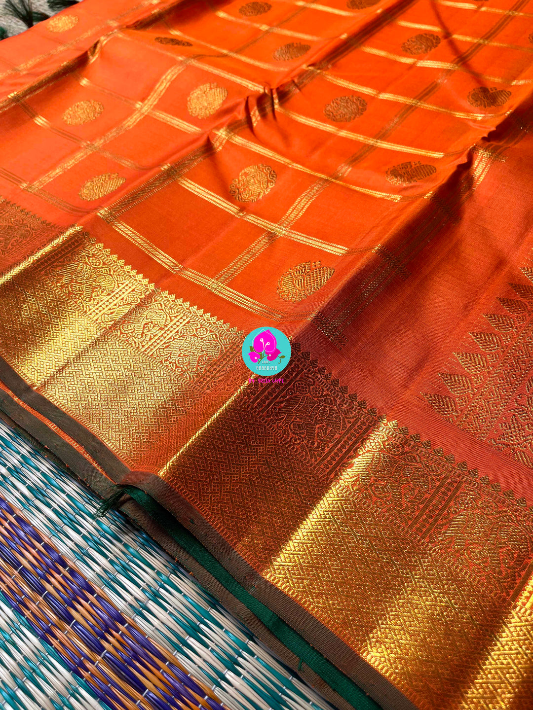 Beautiful orange color pure Kanchipattu saree with Belldari Checkered butta