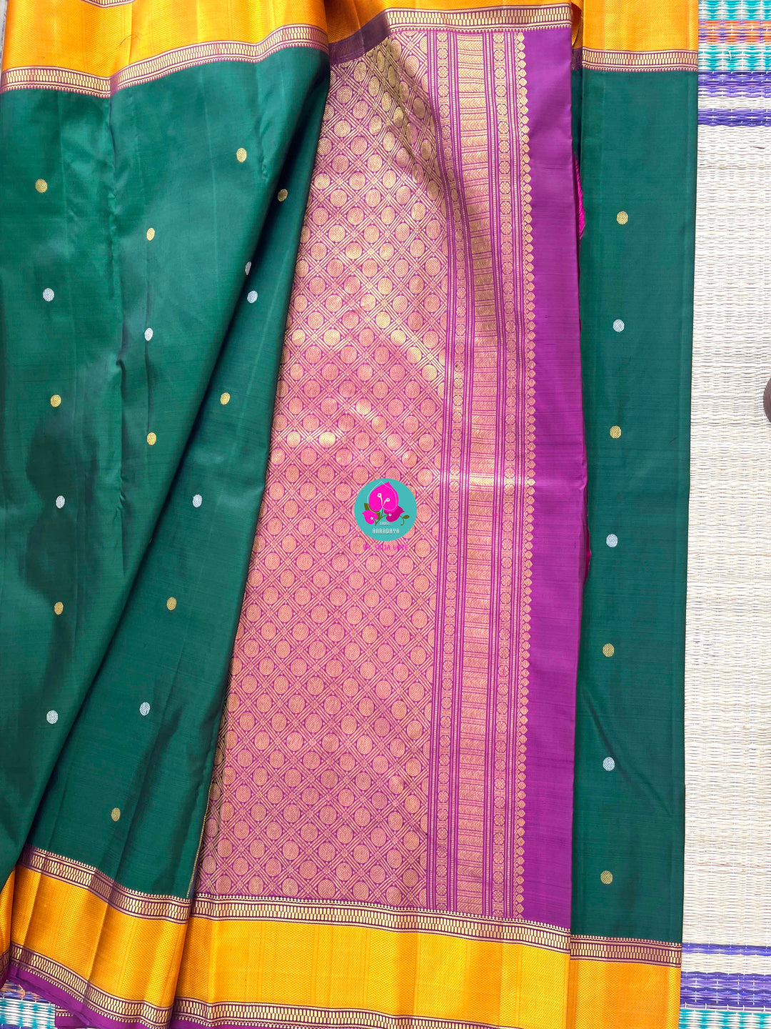 Pure Kanchipattu treasure Bottle green saree with hand embroidered purplish pink blouse