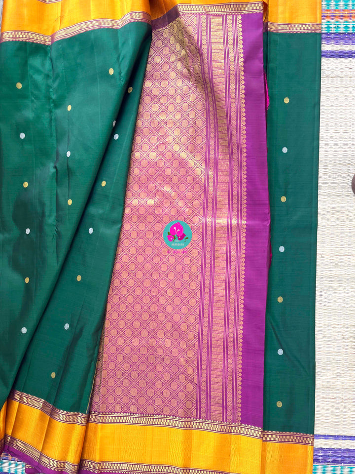 Pure Kanchipattu treasure Bottle green saree with hand embroidered purplish pink blouse
