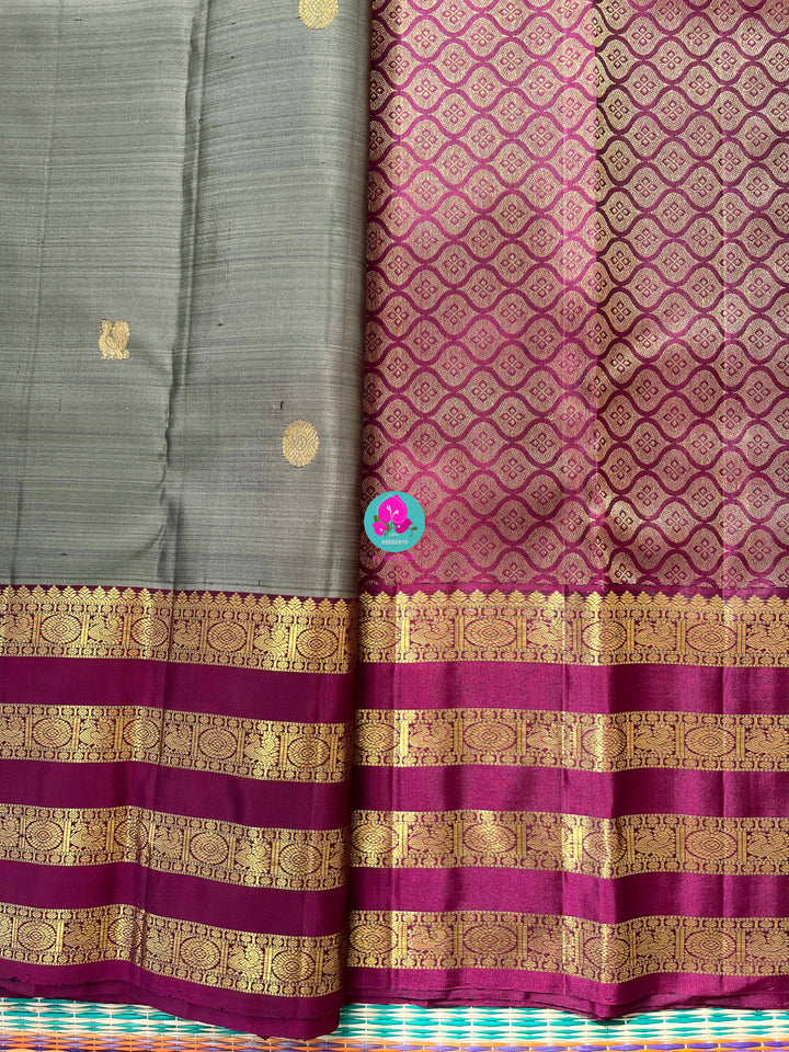 Pure Kanchipattu treasure in Elaichi greenish grey color paired with hand embroidered blouse