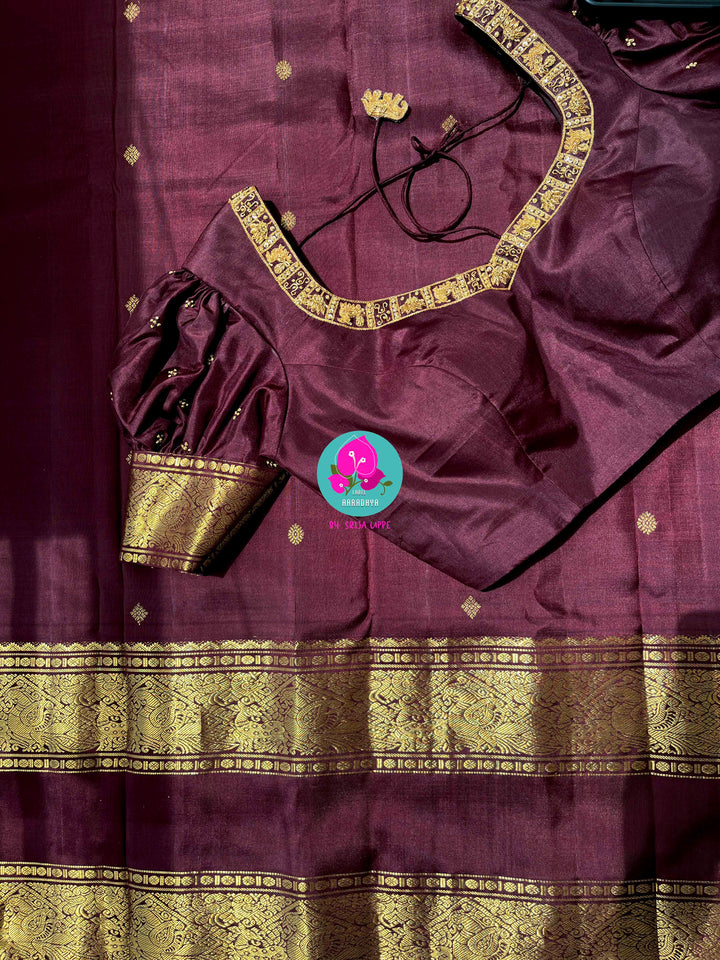Kanchipuram 2g zari brown vintage saree with Hand embroidered Puff sleeves blouse.